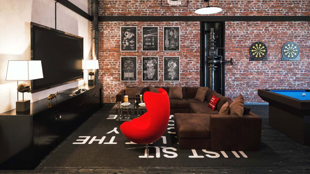 20 Inspiring Small Garage Conversion Ideas 16 Industrial-style entertainment room with exposed brick walls, sectional sofa, red accent chair, pool table, and dart boards