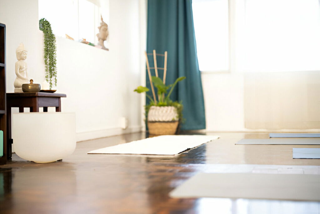 20 Inspiring Small Garage Conversion Ideas 17 Peaceful home yoga and meditation room with yoga mats, a Buddha statue, and natural light