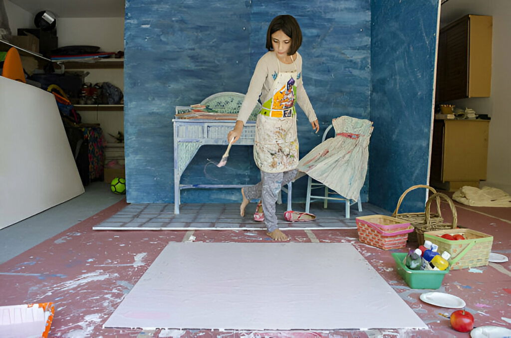 20 Inspiring Small Garage Conversion Ideas 20 Young artist painting in a creative home studio space with colorful supplies and painted furniture