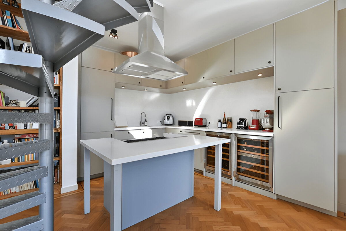 Modern kitchen with white cabinetry and wine coolers