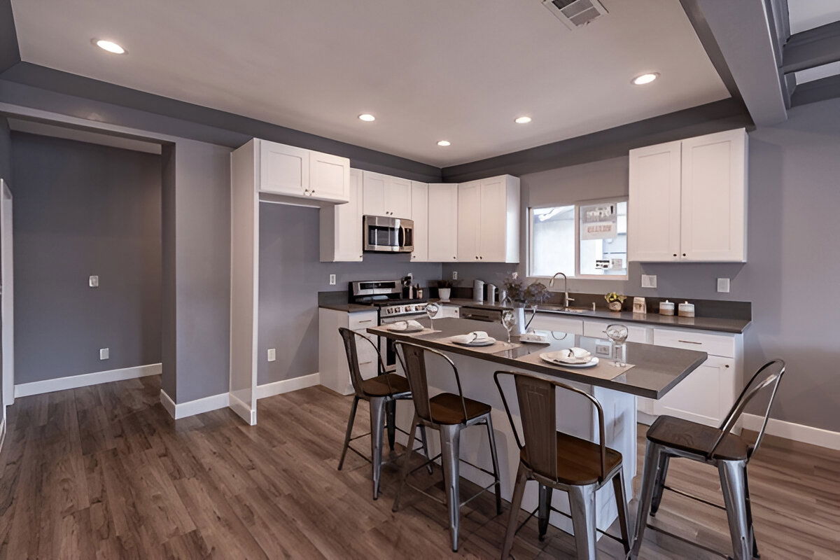 Modern kitchen with gray countertops and white cabinets