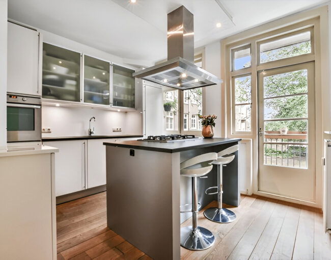 Contemporary kitchen with island and glass cabinets