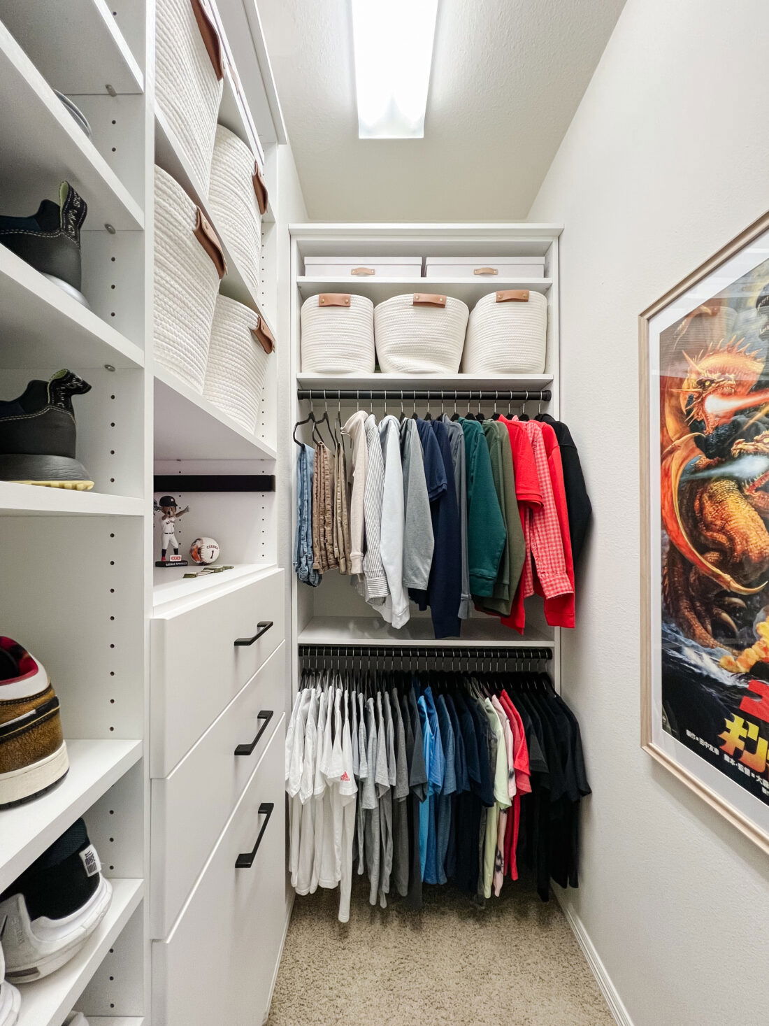 Custom Closet Systems Personalized Guide 13 A compact and well-organized walk-in closet featuring white shelving, built-in drawers, hanging space, and woven storage baskets for a clean and functional design.