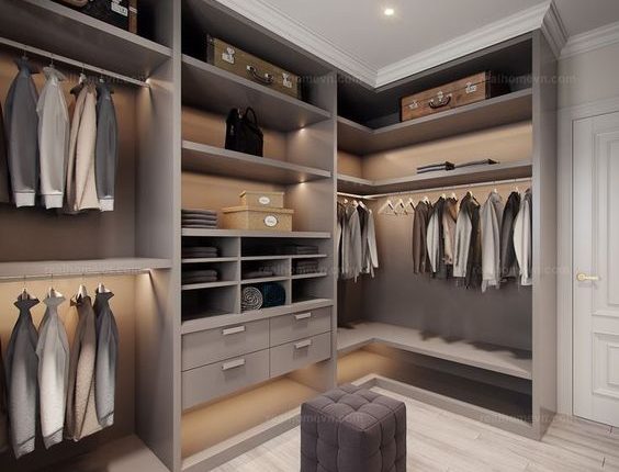 Custom Closet Systems Personalized Guide 8 A modern L-shaped walk-in closet with custom gray shelving, built-in drawers, LED accent lighting, and dedicated storage for clothing, shoes, and accessories.