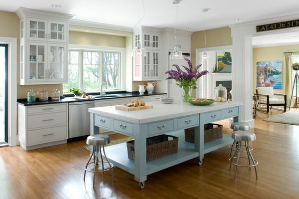 Bright kitchen with blue island and wooden flooring