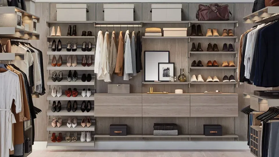 Custom Closet Systems Personalized Guide 11 A modern walk-in closet with custom shelving, dedicated shoe storage, built-in drawers, and stylish organization for clothing and accessories in a sleek neutral-toned design.
