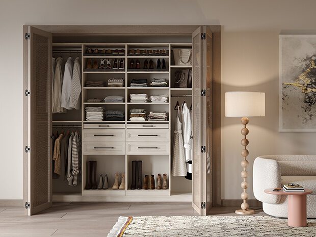 Custom Closet Systems Personalized Guide 10 A beautifully organized reach-in closet with custom shelving, built-in drawers, and ample storage space for clothing, shoes, and accessories, set in a modern neutral-toned room.