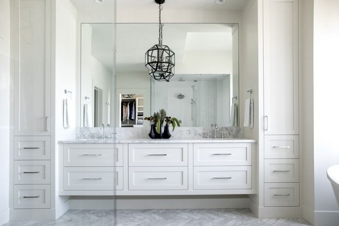 Elegant white double-sink vanity with full wall mirror and black pendant light