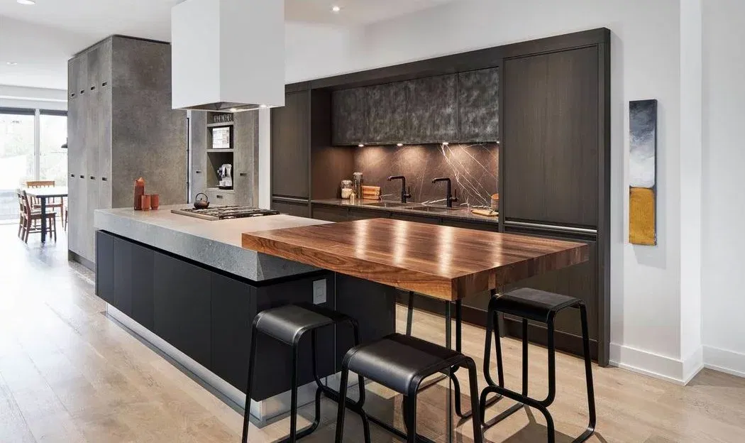 Modern kitchen with concrete island and wood breakfast bar