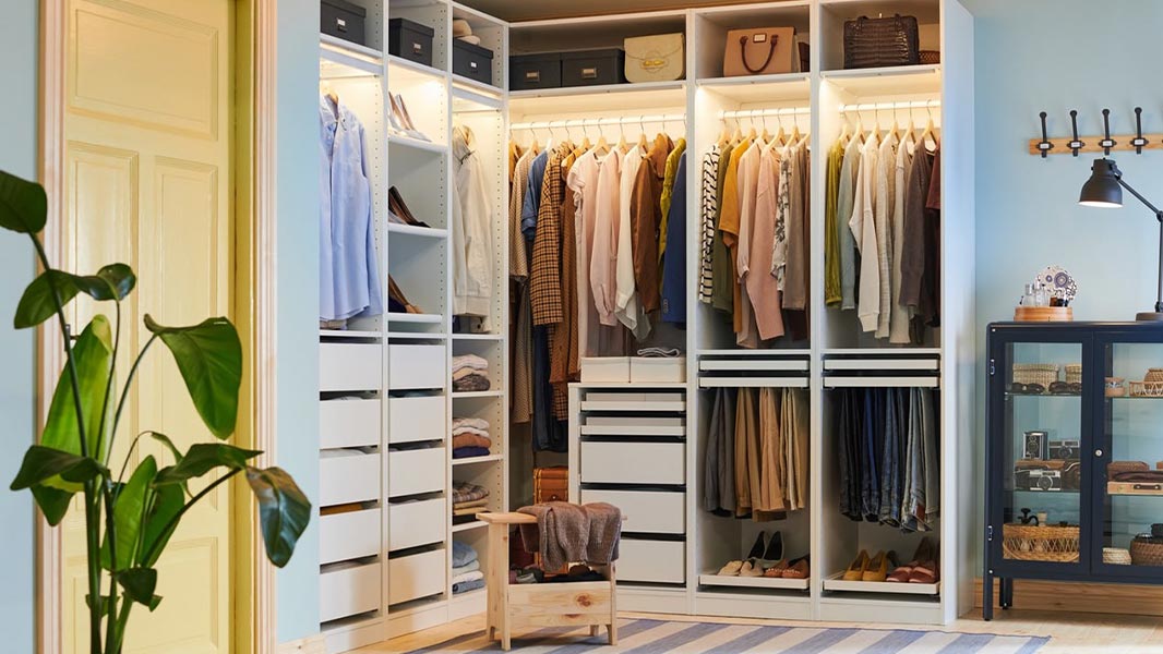 Custom Closet Systems Personalized Guide 12 A modern, well-organized walk-in closet with white shelving, built-in drawers, LED lighting, and dedicated sections for clothing, shoes, and accessories.