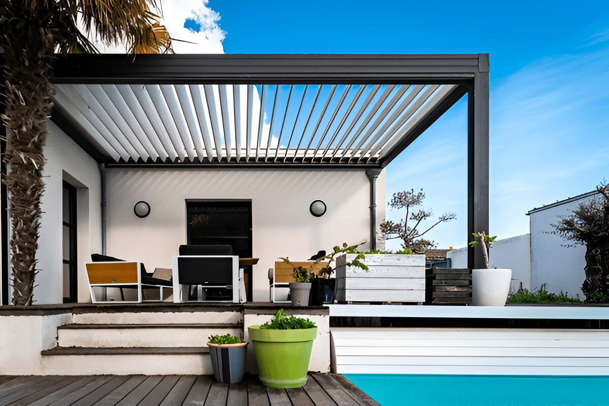 Modern outdoor patio with louvered pergola and poolside seating area