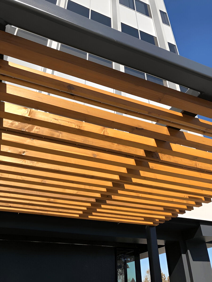 Close-up of modern pergola with angled wooden slats and metal frame