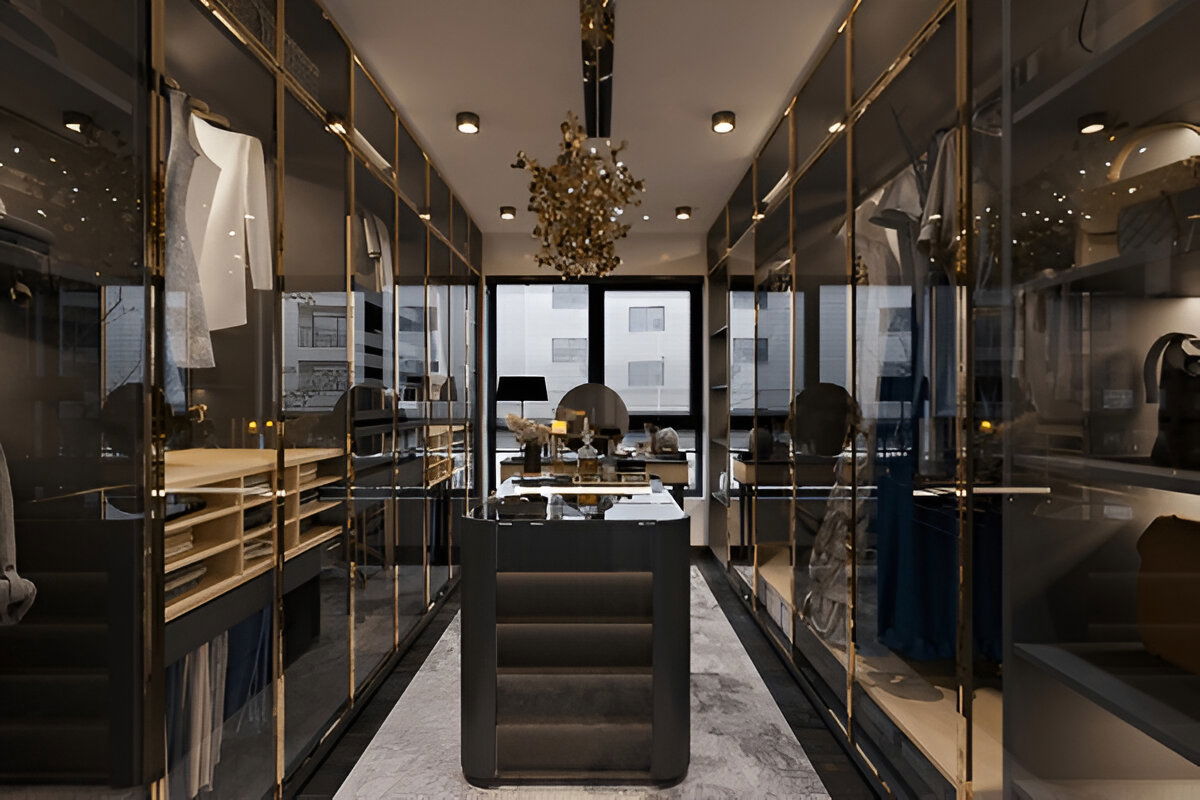 Luxury walk-in closet with glass doors and gold accents 