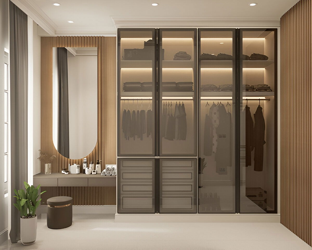 Modern walk-in wardrobe with glass doors and integrated vanity corner

