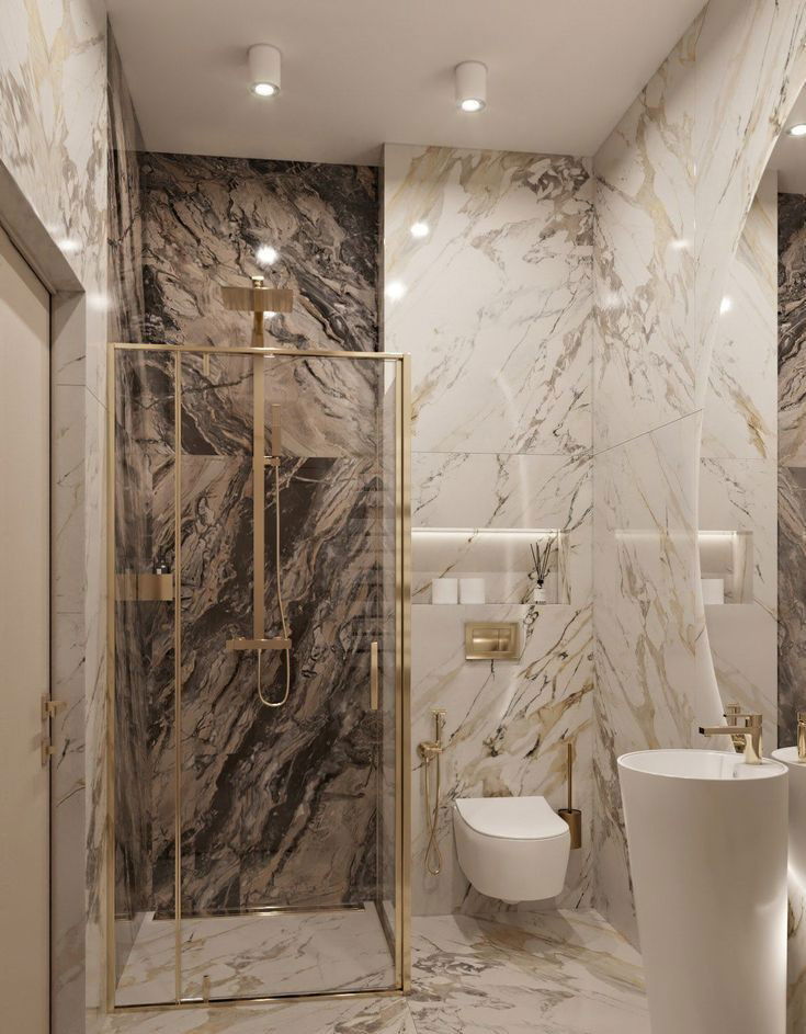 Luxurious marble bathroom with gold fixtures, glass shower enclosure, and modern floating toilet.