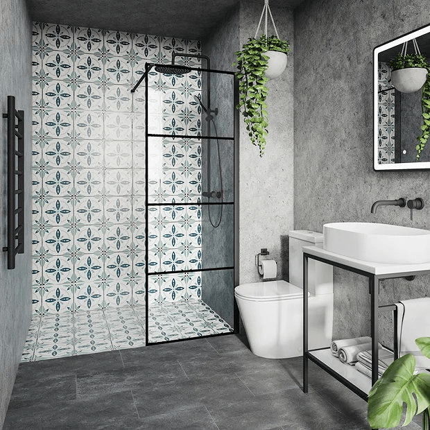 Modern small bathroom with patterned tile shower wall, black-framed glass shower, and concrete walls