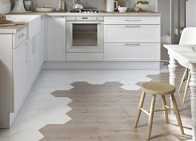 Modern kitchen floor with a creative transition from hexagon white tiles to wood plank flooring