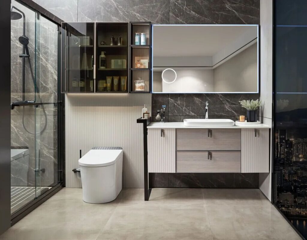 Custom Cabinetry Trends for Bathrooms to Watch in 2025 8 Contemporary bathroom with a smart toilet, floating vanity, LED mirror, and glass-enclosed shower against dark marble walls.
