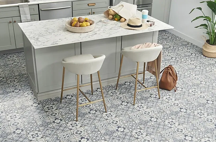 Modern kitchen with a gray island, white marble countertop, and stylish patterned vinyl sheet flooring in blue and white tones.