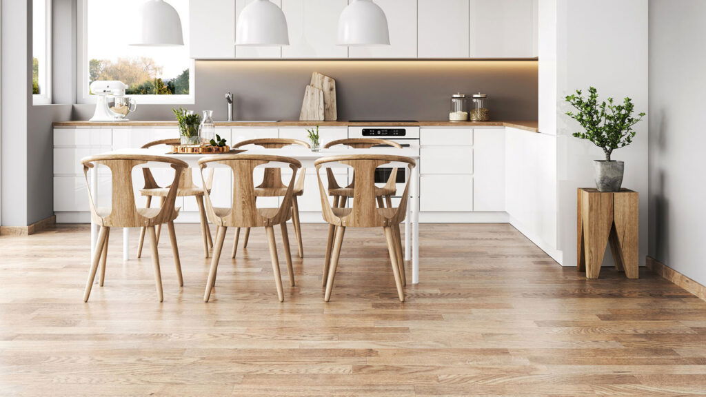 Minimalist white kitchen with natural light wood flooring and Scandinavian-style dining set.