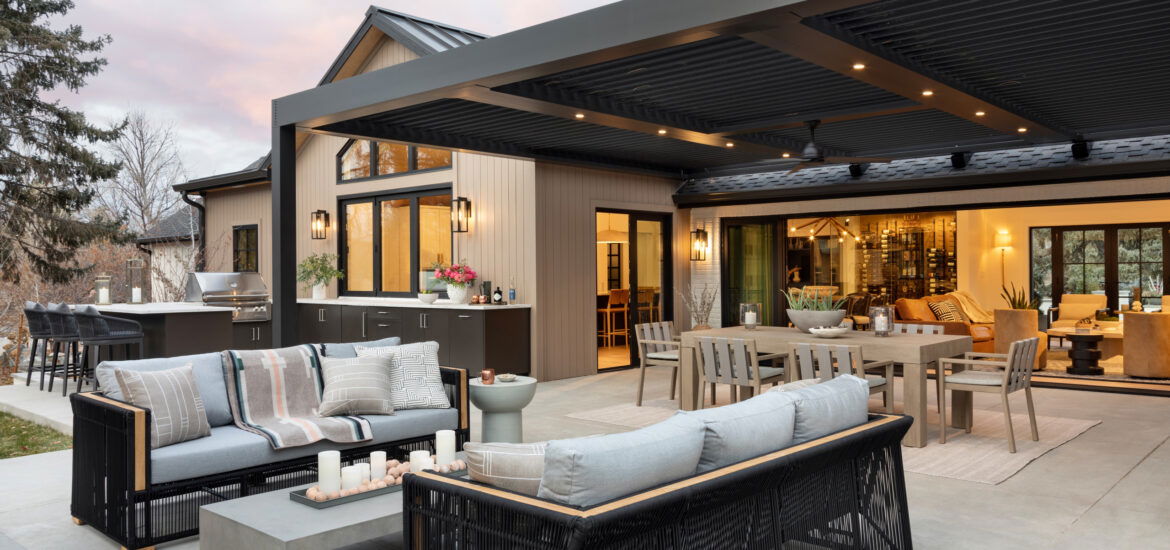 Stylish covered patio with modern outdoor kitchen, dining area, and lounge seating.
